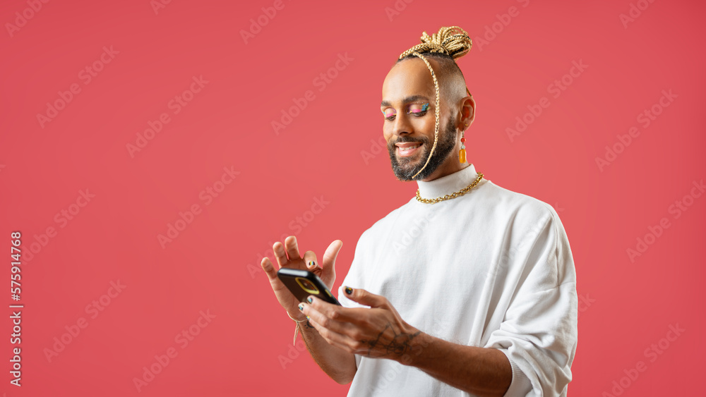African-american gay use smartphone isolated on pink