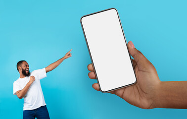 Poster - Online Offer. Cheerful Black Man Pointing At Huge Hand With Blank Smartphone