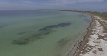 The Flight Of A Drone, Panorama Is A Narrow Sandy Strip Of The Island Of Dzharylgach With A Rare Vegetation In The Black Sea Near The City Of Skadovsk, Ukraine, Calm Azure Water