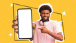 © Prostock-studio - Modern african man with headphones showing blank cellphone screen, mockup