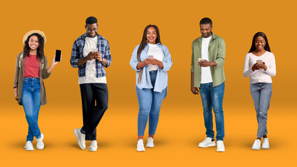 Wall Mural - Cheerful young african american people in casual typing on phones, show phone with blank screen