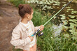 © Seventyfour - High angle portrait of black little girl fishing by forest lake and enjoying nature, copy space