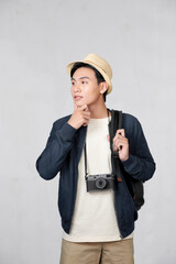 Wall Mural - Smiling funny young traveler tourist man in hat with photo camera isolated on white background