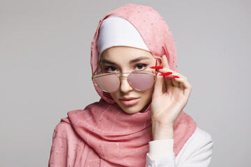 Wall Mural - beautiful islamic young woman with long Nails. beauty girl in hijab and sunglasses