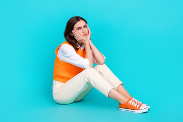 Wall Mural - Full body length photo cadre of young depressed university learner girl touch cheeks pouted lips problems isolated on aquamarine color background