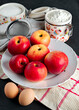 still life with apples spread out on a plate kitchen towel and flour