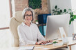 © deagreez - Photo of cheerful successful aged lady company founder sitting chair keyboard write message communicate workplace indoors