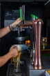© Rafa - hombre barman con gorro de vaquero preparando un cóctel azul en la barra del bar