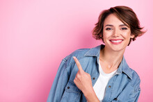 Photo Portrait Of Cheerful Pretty Woman Wear Denim Jacket Directing Finger Empty Space Opening Whitening Dentistry Isolated On Pink Color Background
