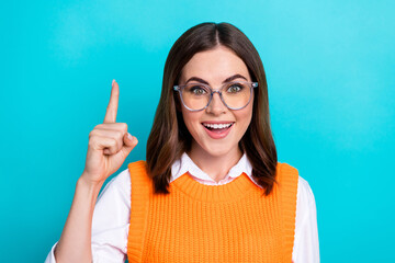 Poster - Photo of good mood funny cute clever woman with bob hairstyle orange waistcoat raise finger up good idea isolated on teal color background