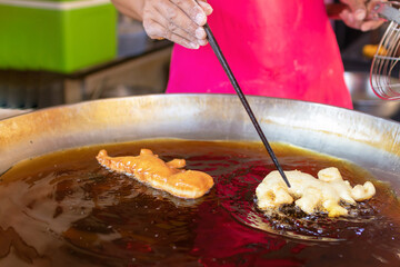 Wall Mural - Deep-fried crullers, also known as (Pa Thong Ko). Each deep-fried treat is hand-crafted elephant or dragon with a side of hot soy milk, soft-boiled eggs (“kai luok“) or coconut custard.