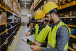 © Halfpoint - Warehouse workers checking stuff in warehouse with digital system in tablet.