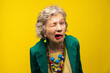 © VISTA by Westend61 - Senior woman making funny faces against yellow background