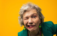Senior woman with facial expressions in front of yellow background