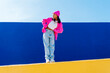 © VISTA by Westend61 - Young woman with hand on hip dancing on wall