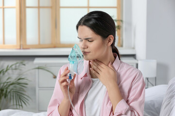 Poster - Sick young woman using nebulizer at home