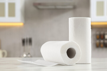 Wall Mural - Rolls of paper towels on white marble table in kitchen. Space for text