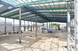 construction site of commercial warehouse building showing various materials and frame of building