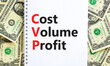 © Dzmitry - CVP cost volume profit symbol. Concept words CVP cost volume profit on white note on a beautiful background from dollar bills. Business and CVP cost volume profit concept. Copy space.
