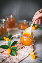 Crop Person Taking Kumquat Jam With Spoon