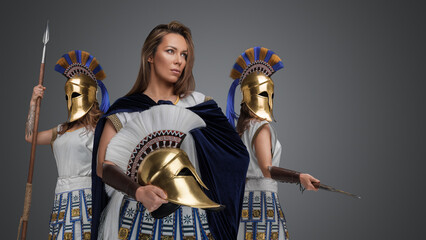 Wall Mural - Portrait of three greek female warriors with spears and golden plumed helmets.