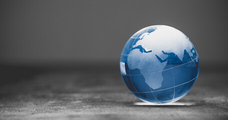 Blue world globe crystal glass on black background
