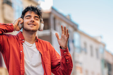 Poster - young man enjoying listening to music with headphones