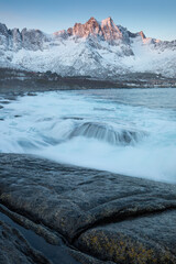 Wall Mural - Snow covered mountain range on coastline in winter, Norway. Senja panoramic aerial view landscape nordic snow cold winter norway ocean cloudy sky snowy mountains. Troms county, Fjordgard 