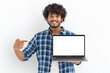© kucherav - Portrait of young Asian man student with laptop on white background. Happy male with curly hair points her finger at a blank laptop screen, looking at the camera and smiling