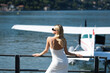 © Volodymyr - Woman tourist walking on street, summer fashion style, travel to Europe. Fashion tourist. Elegant woman tourist in trendy dress near jet. Travel tourist in Como lake Italy.