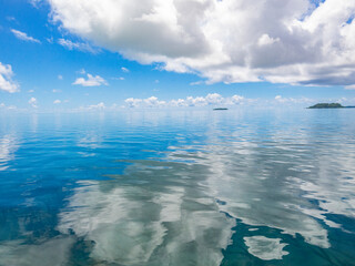 Wall Mural - Blue sky and small tropical islands, reflection on calm ocean, Carp island, Palau, Pacific