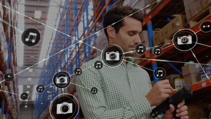 Poster - animation of network of digital icons over caucasian male supervisor checking stock at warehouse