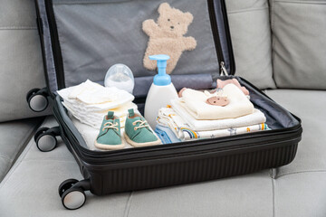 Bag for maternity hospital. Suitcase of baby clothes prepared for newborn birth. Concept of getting ready for the maternity hospital, packing baby stuff