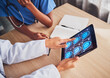 © Sharne T/peopleimages.com - Doctor, tablet and brain xray, neurology and digital test results, people and healthcare team in hospital. MRI, technology and screen in hands, cancer and radiology, anatomy and health assessment