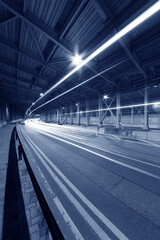Poster - light trails and head lights of traffic in tunnel. Transportation background