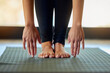 Hands, feet and woman stretching on yoga mat for exercise, cardio and flexibility warm up in her home. Barefoot, hand and girl stretch for meditation, training for pilates workout in a living room