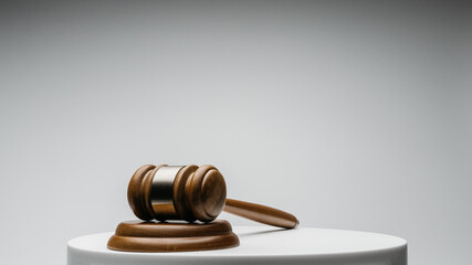 Wall Mural - Brown wooden judge gavel on gray background