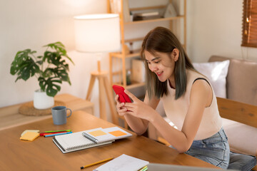 Creative design concept, Fashion designer surfing social media on smartphone to relax in workplace