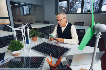 Wall Mural - Male mature architect working on an ecological construction project in office