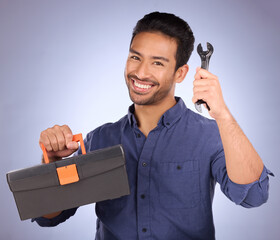 Poster - Portrait, tool and Asian man with box, smile and maintenance with guy against blue studio background. Face, male employee and handyman with happiness, equipment and contractor with service and happy