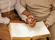 © Joanrae P/peopleimages.com - Bible, holding hands and reading with a black couple together in the home for religion, faith or belief in God. Jesus, pray or book with a christian man and woman learning about the spiritual christ