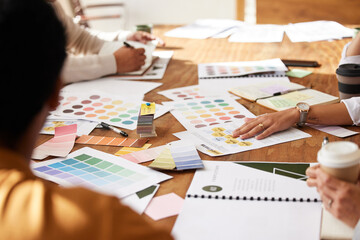 Meeting, discussion and creative team planning a project together in office boardroom. Brainstorming, design and group of people working in collaboration with color swatches or palette in workplace.