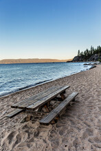 An Empty Picnic Table On The Beach At Lake Tahoe.