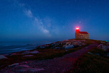 Old Lighthouse On Coast Under Starry Sky