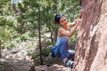 Strong Female Looking Towards Next Move On A Boulder Problem