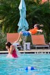 © Cavan Images - Kid jumps in Swimming pool