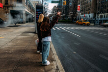 Teen Girl Hailing Cab In New York City