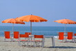 Versilia. Umbrellas on the beach. The sea of Viareggio in Versilia. In the background a yacht. 
