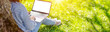 © candy1812 - Woman with laptop sitting on the grass in the natural park.