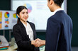 © Bangkok Click Studio - Millennial professional successful male businessman and female businesswoman in formal business suit shaking hands greeting deal done job agreement achievement